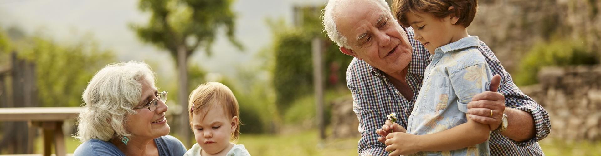 abuelos-hablando-a-ninos-campo.-familia.-margaritas